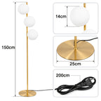 Lampadaire trois boules de verre blanc en cascade, pied doré