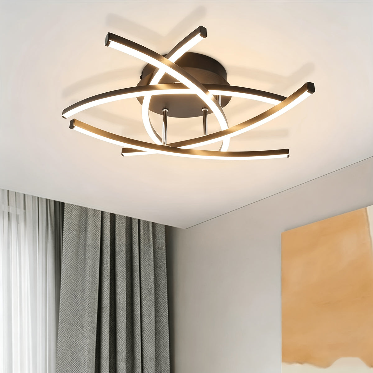 Plafonnier design aux arcs lumineux qui se croisent