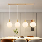 Suspension 4 globes en verre blanc strié sur barre dorée de 86 cm