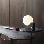 Lampe à poser globe en verre sur bloc de métal, variateur rotatif
