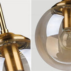 Petite suspension globe en verre Ø 15 cm, tube doré, câble 80 cm
