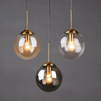 Petite suspension globe en verre Ø 15 cm, tube doré, câble 80 cm