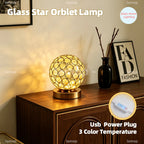 Lampe à poser globe en métal ajouré et cristal, dorée ou argentée