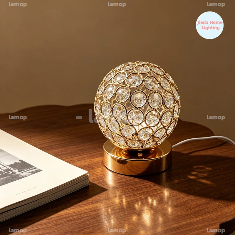 Lampe à poser globe en métal ajouré et cristal, dorée ou argentée