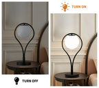 Lampe de chevet noire, globe en verre opalin dans un arceau