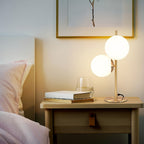 Lampe de chevet à deux globes en verre opalin, pied doré ou noir